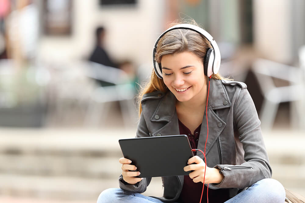 Girl with tablet and headphones